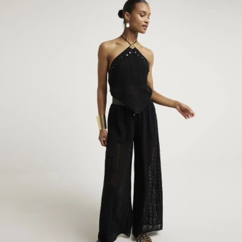 Black crochet halter neck top sold by River Island