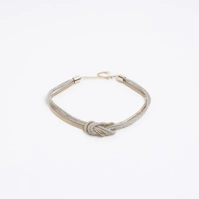 Gold mixed metal knot collar necklace sold by River Island