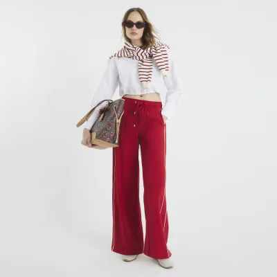 Red Wide Leg Side Stripe Joggers sold by River Island