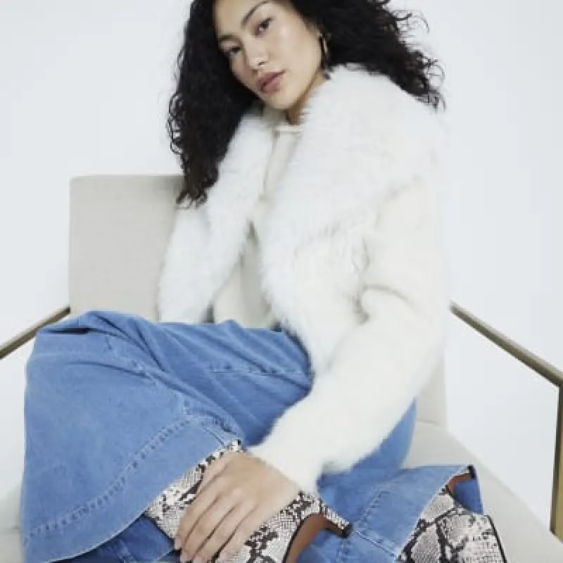 Cream faux fur crop gilet sold by River Island