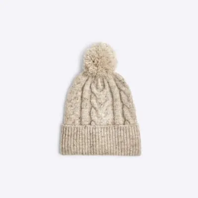 Cream cable knit beanie hat sold by River Island