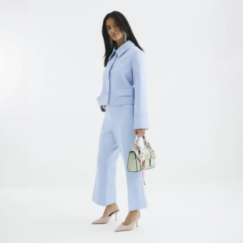 Petite Blue Cropped Flared Trousers sold by River Island