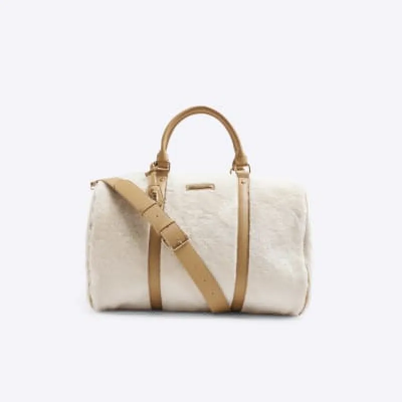 Cream Faux Fur Lock Luggage Bag sold by River Island