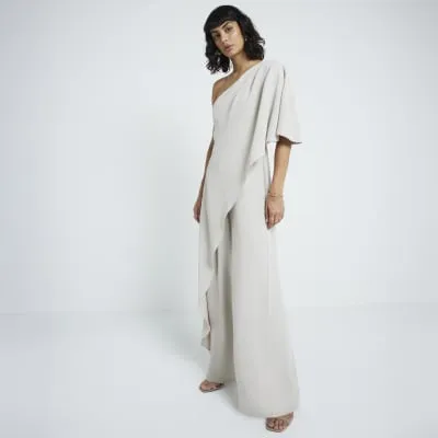 Cream overlay one shoulder jumpsuit sold by River Island