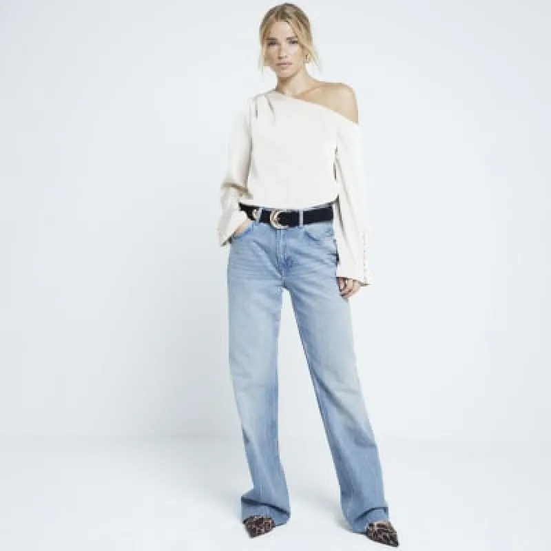 Cream one shoulder cuffed blouse sold by River Island