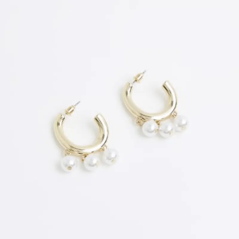 Gold pearl drop hoop earrings sold by River Island