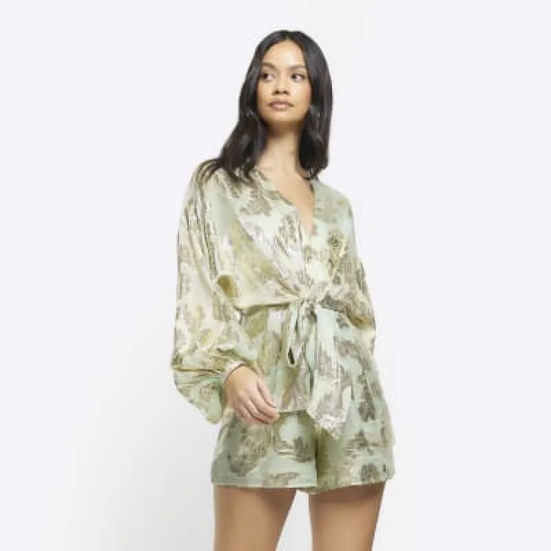 Green metallic detail tie waist playsuit sold by River Island