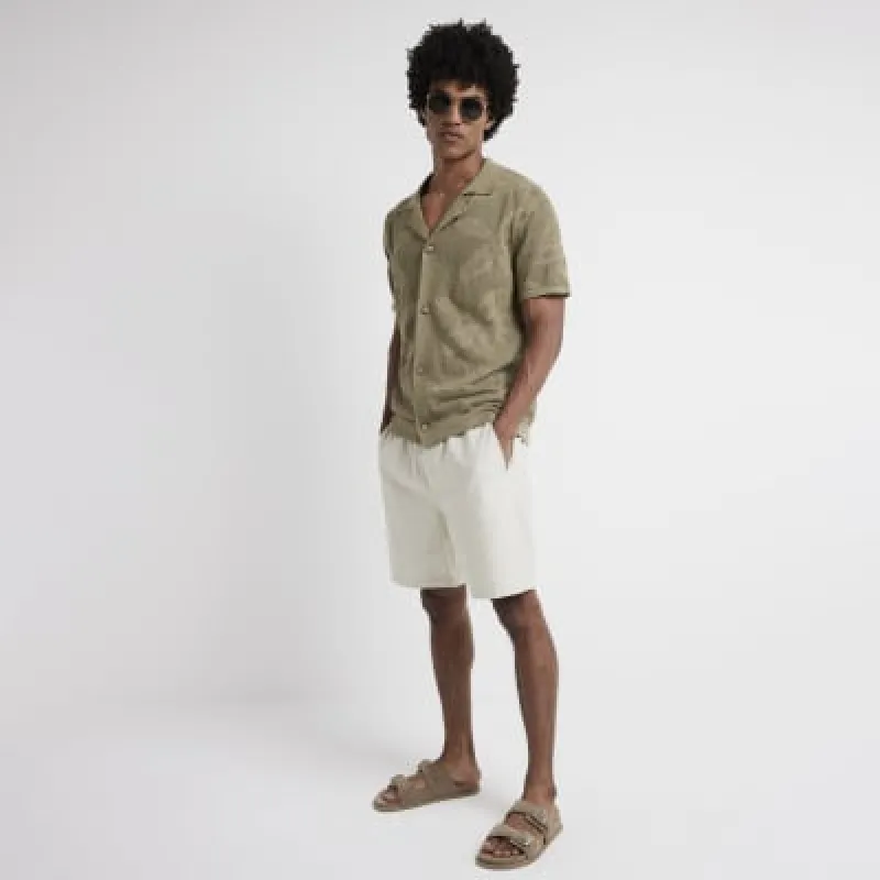 Khaki slim fit crochet floral polo shirt sold by River Island