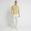 Blue tapered fit bleached jeans sold by River Island