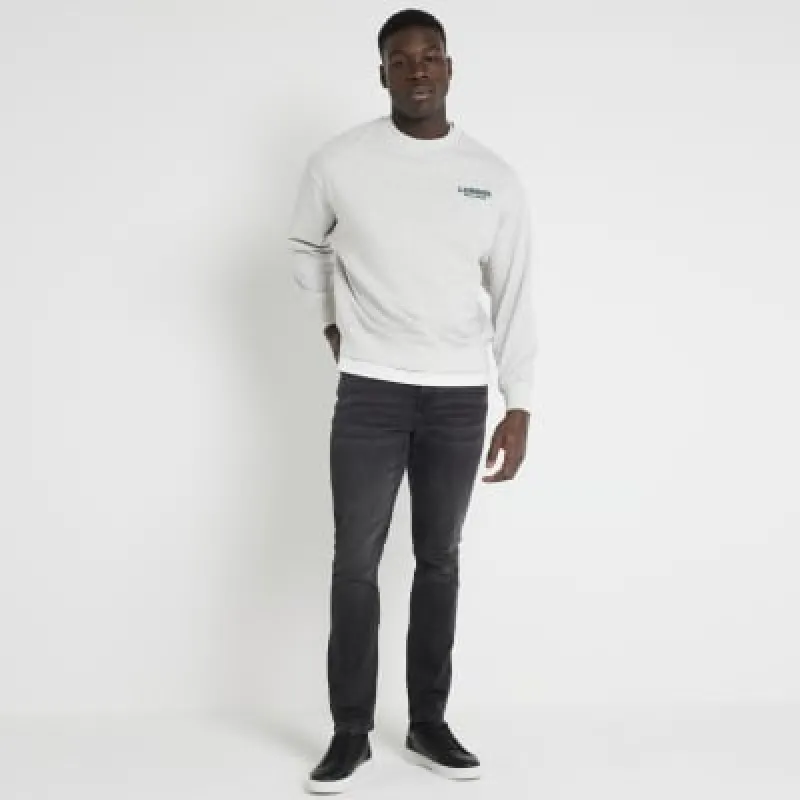 Washed black skinny fit jeans made by River Island