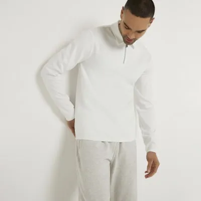 Beige slim fit textured half zip polo sold by River Island