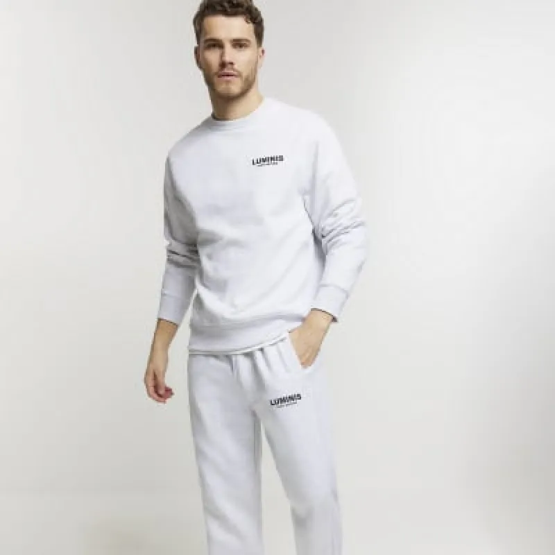 Grey regular fit graphic cuffed joggers sold by River Island