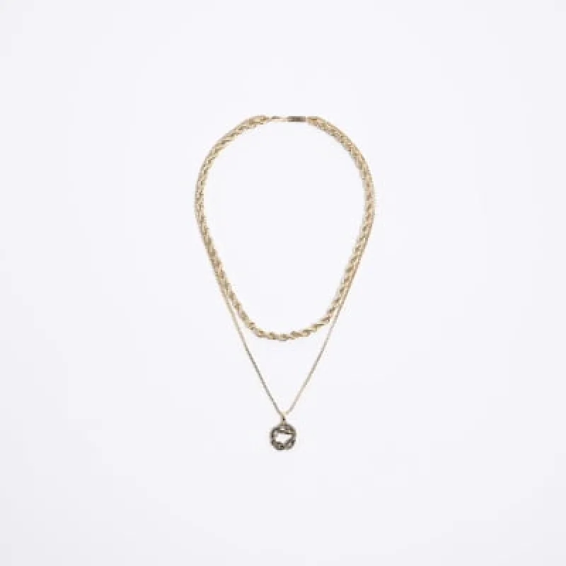 Gold colour snake pendant necklace sold by River Island