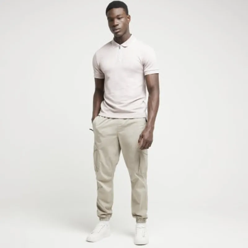 Pink slim fit textured half zip polo sold by River Island