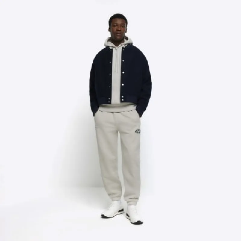 Grey regular fit graphic cuffed joggers sold by River Island
