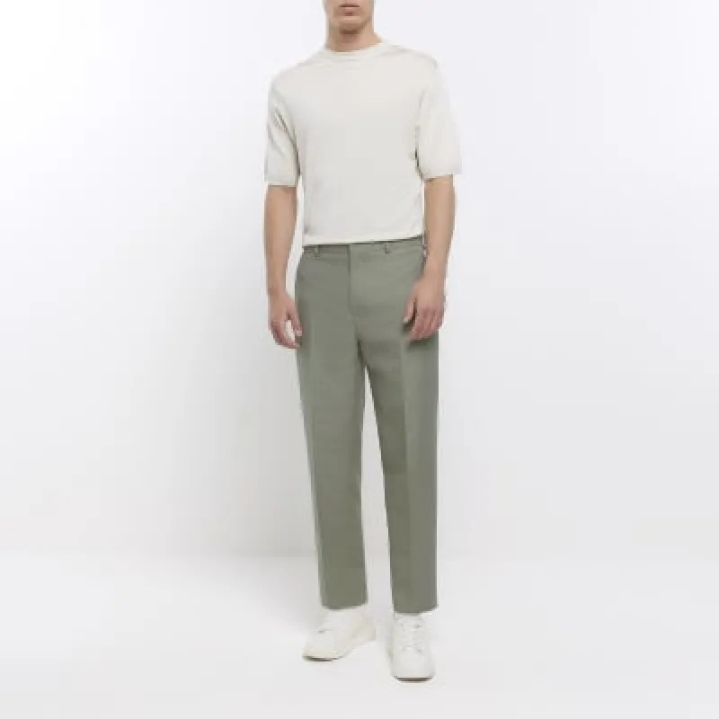 Sage green tapered fit textured trousers sold by River Island