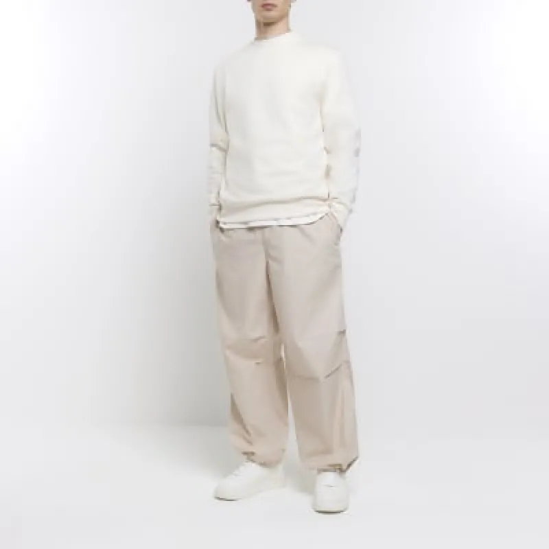 Stone regular fit parachute trousers sold by River Island