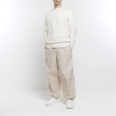 Stone regular fit parachute trousers sold by River Island