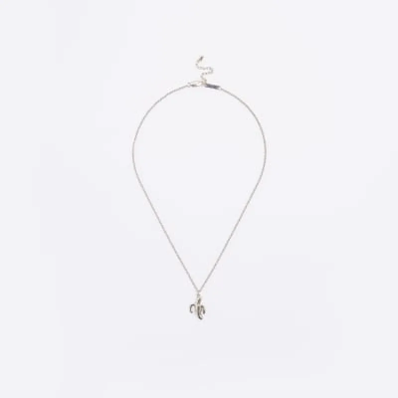 Silver colour banana pendant necklace sold by River Island