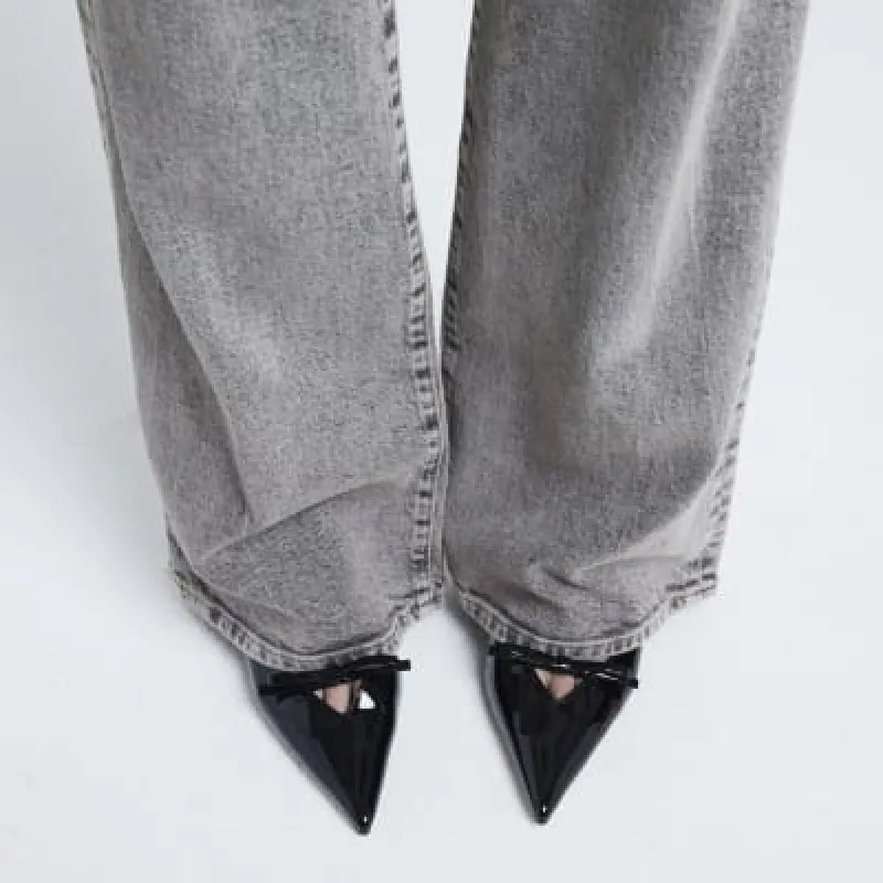 Black patent bow sling back heeled shoes sold by River Island