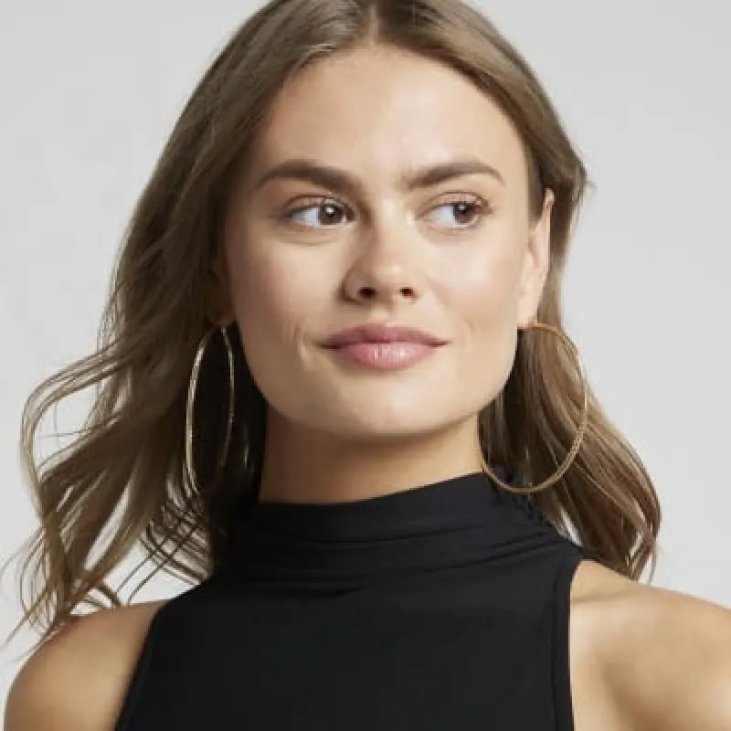 Gold textured large hoop earrings sold by River Island