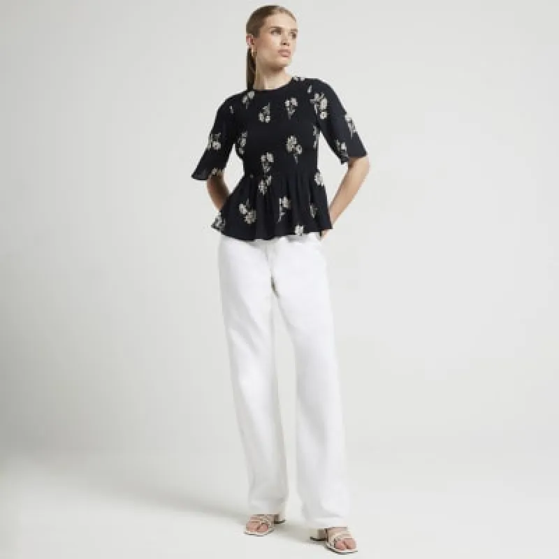 Black floral peplum top sold by River Island
