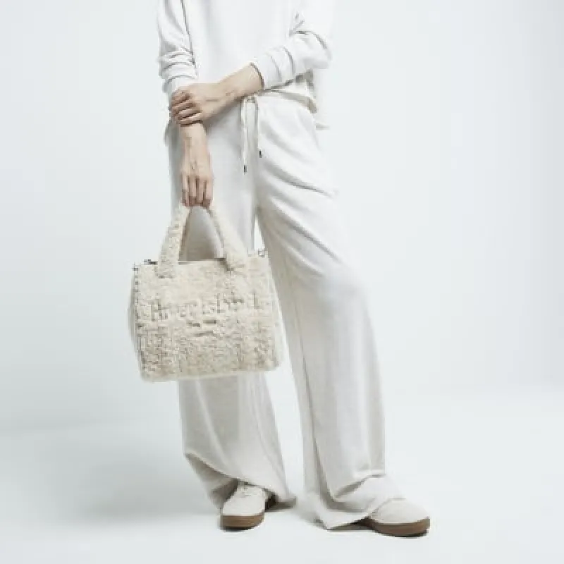 Cream borg embossed tote bag sold by River Island