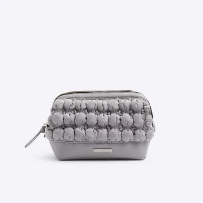 Grey quilted makeup bag sold by River Island
