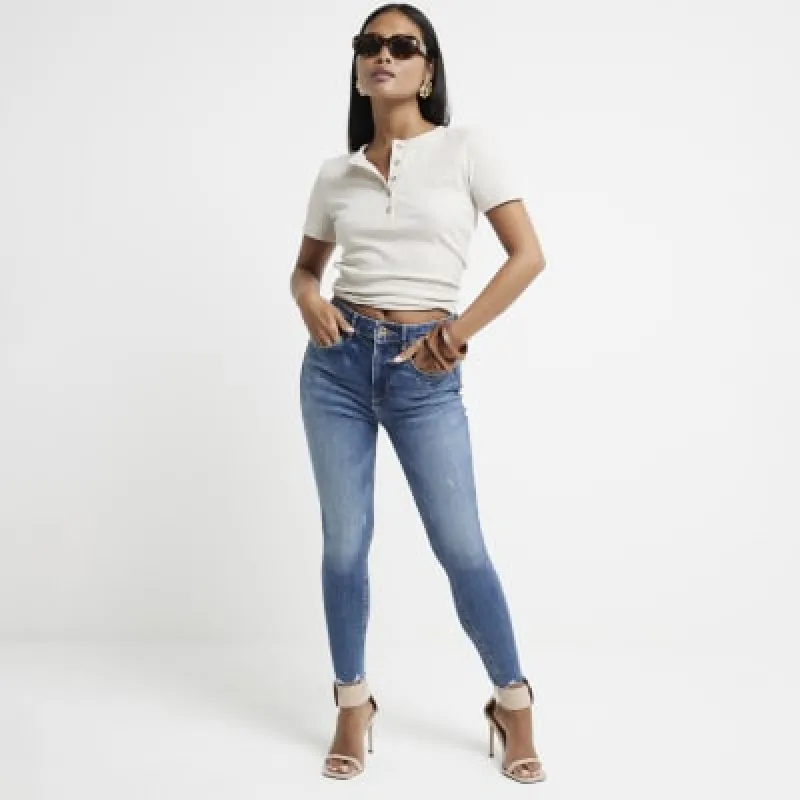 Petite blue high waisted skinny jeans sold by River Island