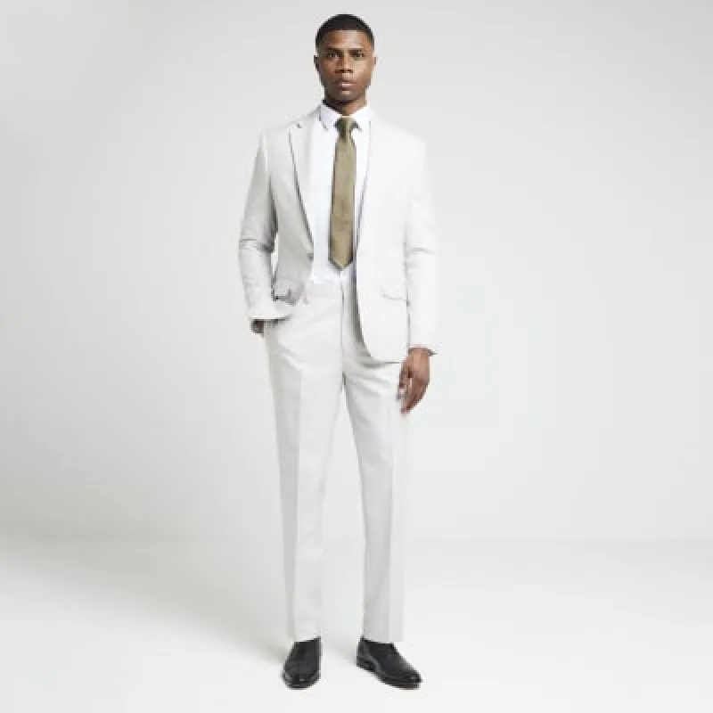 Beige slim fit textured suit trousers sold by River Island