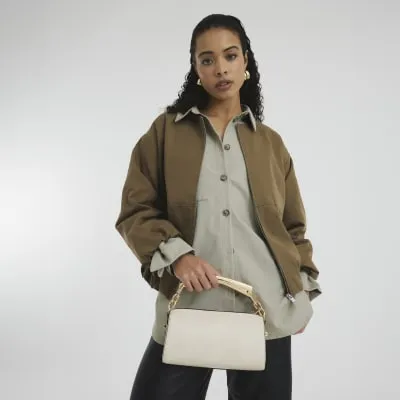Cream Metal Handle Crossbody Bag sold by River Island