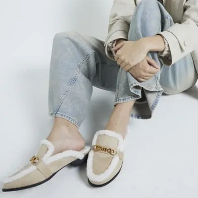 Beige faux fur mules sold by River Island