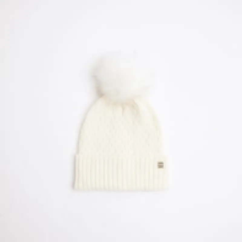 Cream pom pom cable knit beanie hat sold by River Island