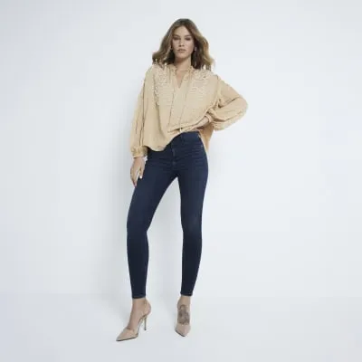 Blue denim mid rise molly sculpted jeans sold by River Island
