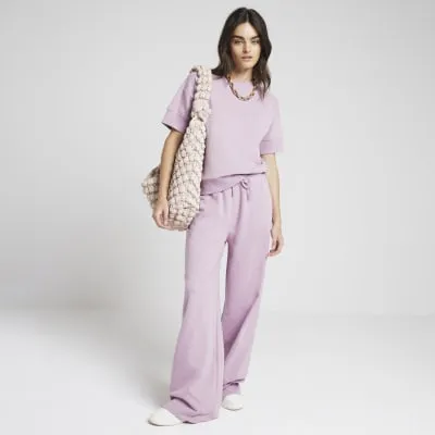 Pink drawstring wide leg joggers sold by River Island
