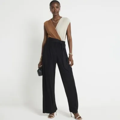 Brown plisse belted wrap jumpsuit sold by River Island