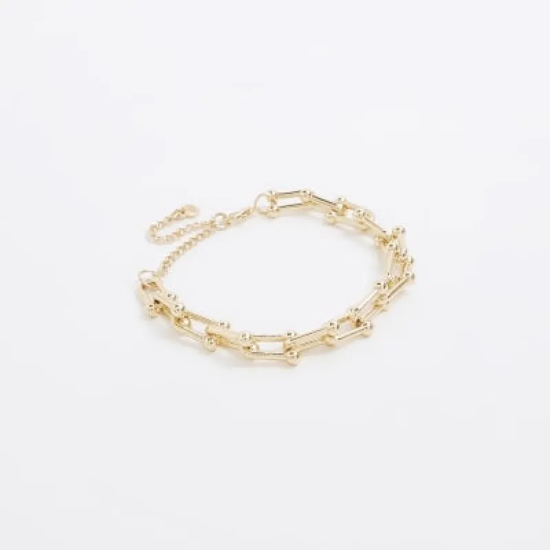 Gold chain link bracelet sold by River Island