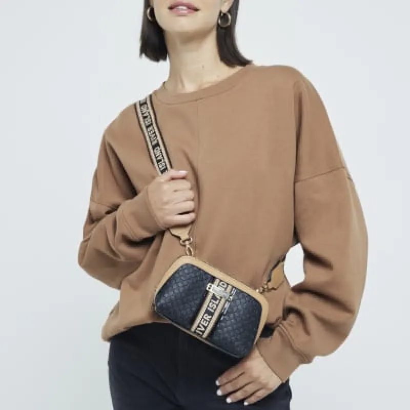 Black RI monogram webbing cross body bag sold by River Island