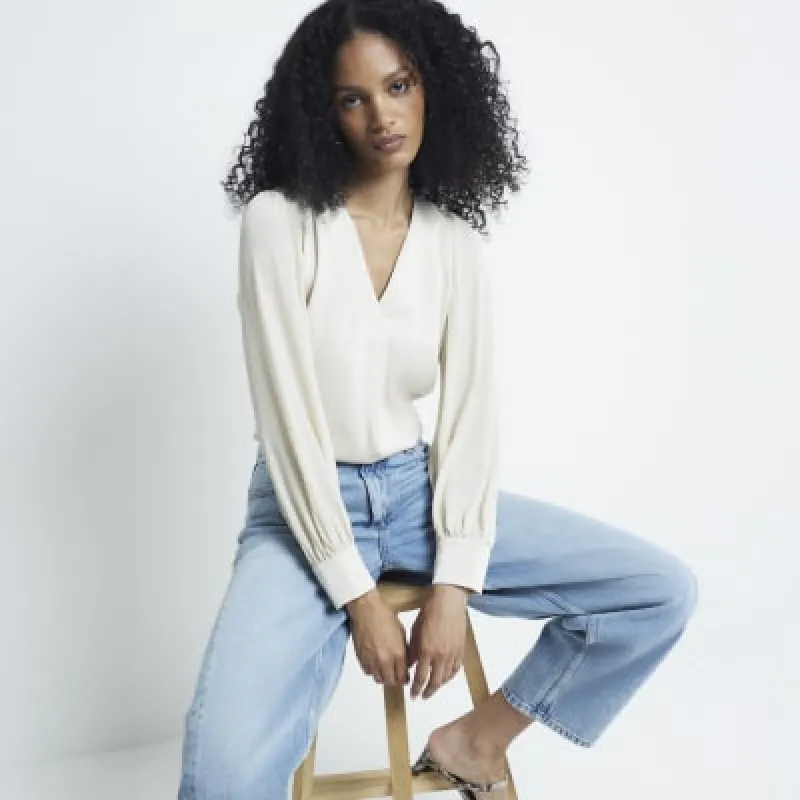 Cream Sheer sleeve V-neck top sold by River Island