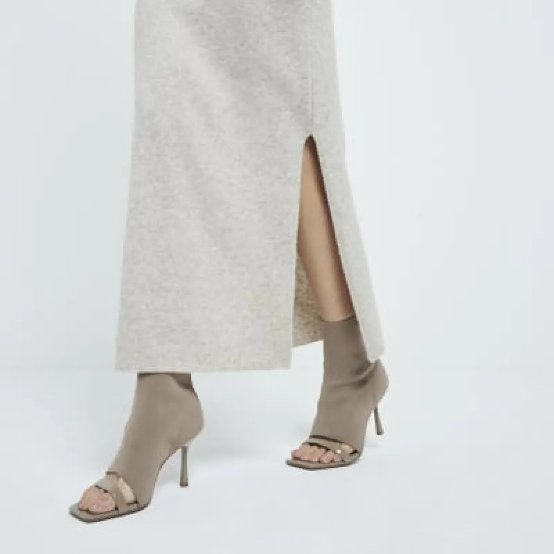 Beige knit sock boot sandals sold by River Island