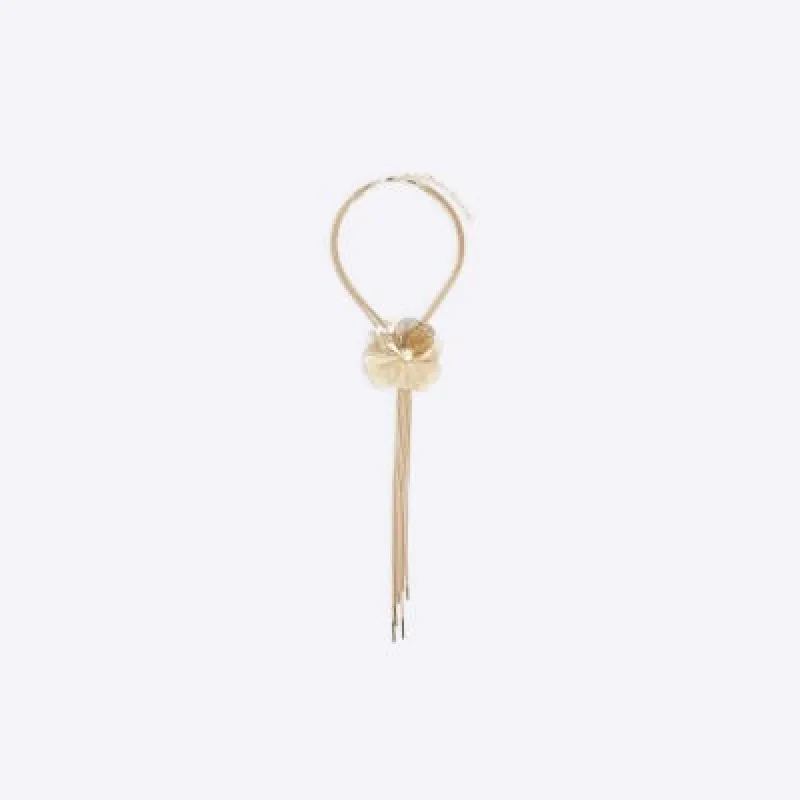 Gold flower drape necklace sold by River Island