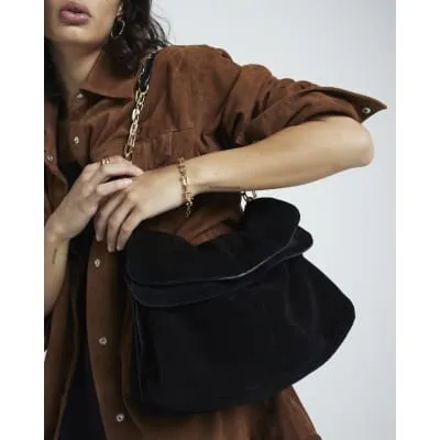 Black slouchy suede shoulder bag sold by River Island