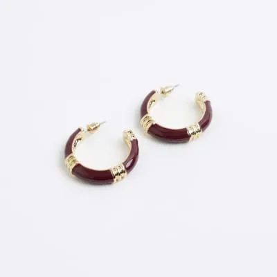 Red enamel hardware hoop earrings sold by River Island