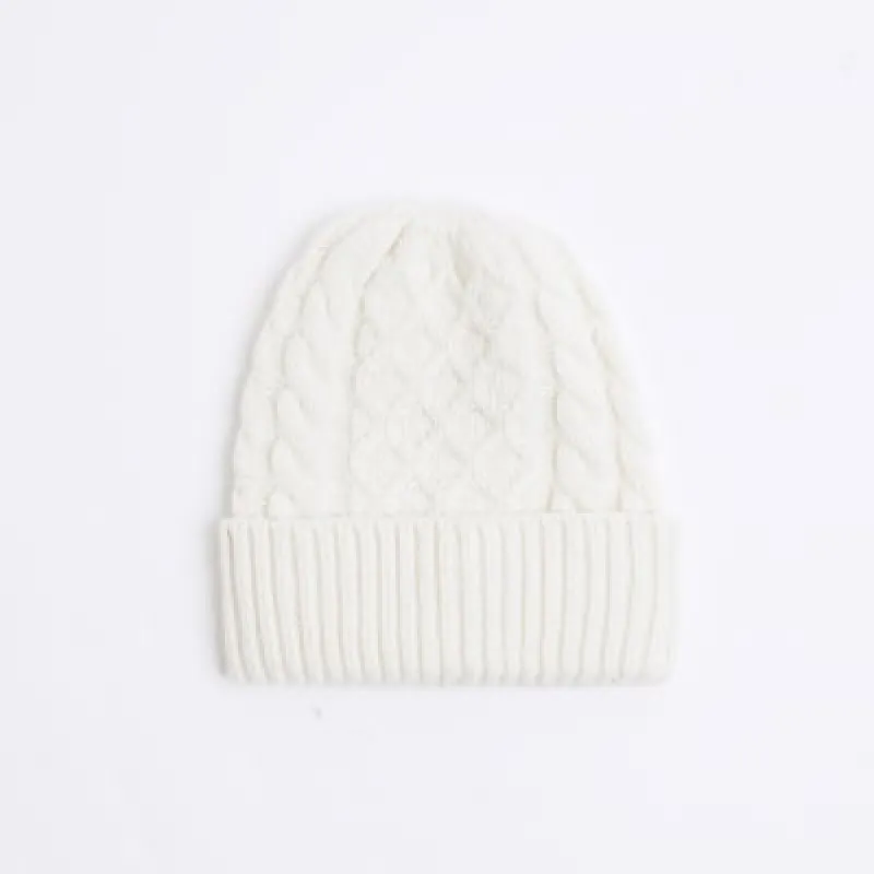 Beige chunky cable knit beanie sold by River Island