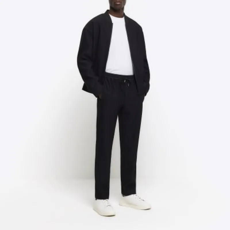 Black tapered fit plisse smart joggers sold by River Island