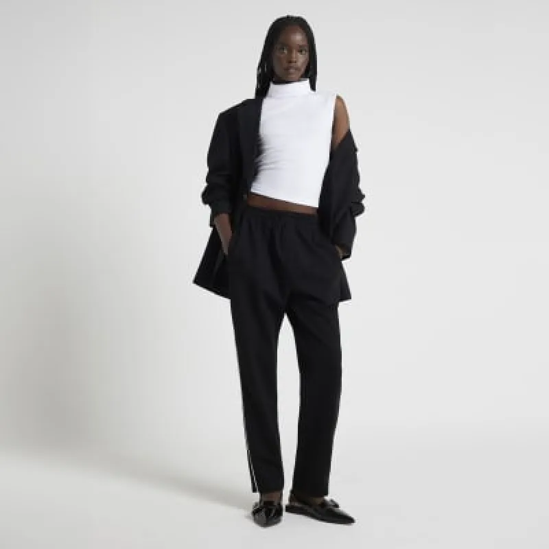 White sleeveless chunky ribbed roll neck top sold by River Island