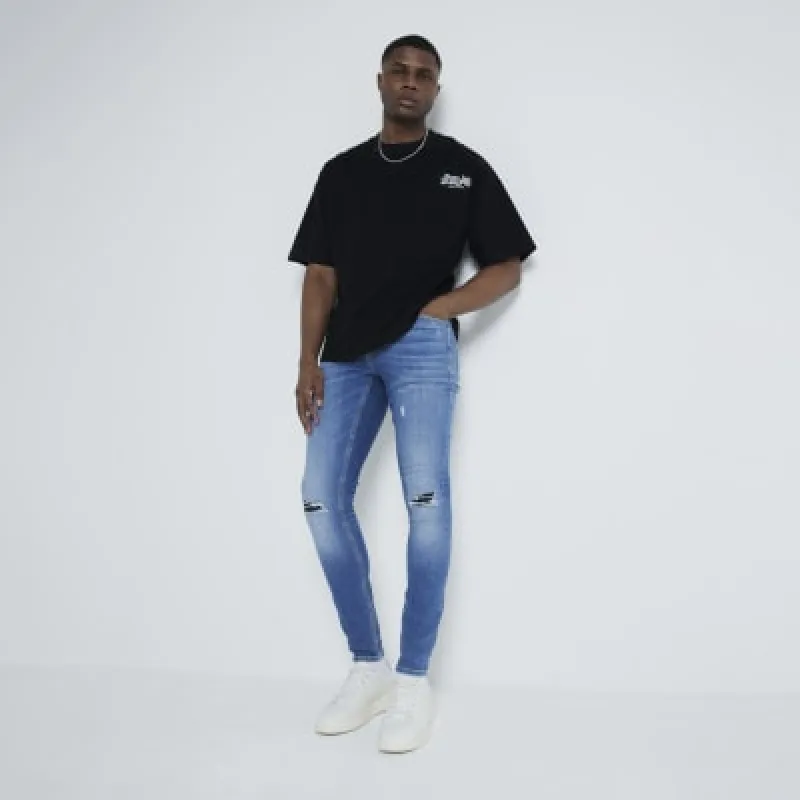 Blue Super Skinny Spray On Ripped Jeans sold by River Island