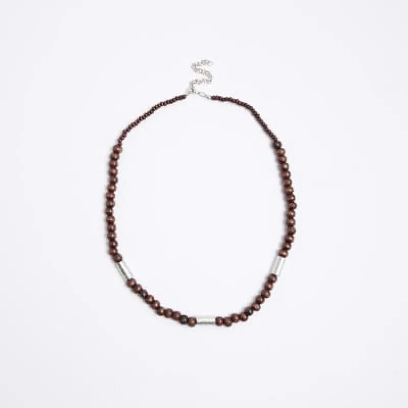 Brown wooden and metal necklace sold by River Island