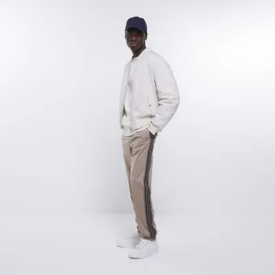 Stone slim fit striped tapered joggers sold by River Island