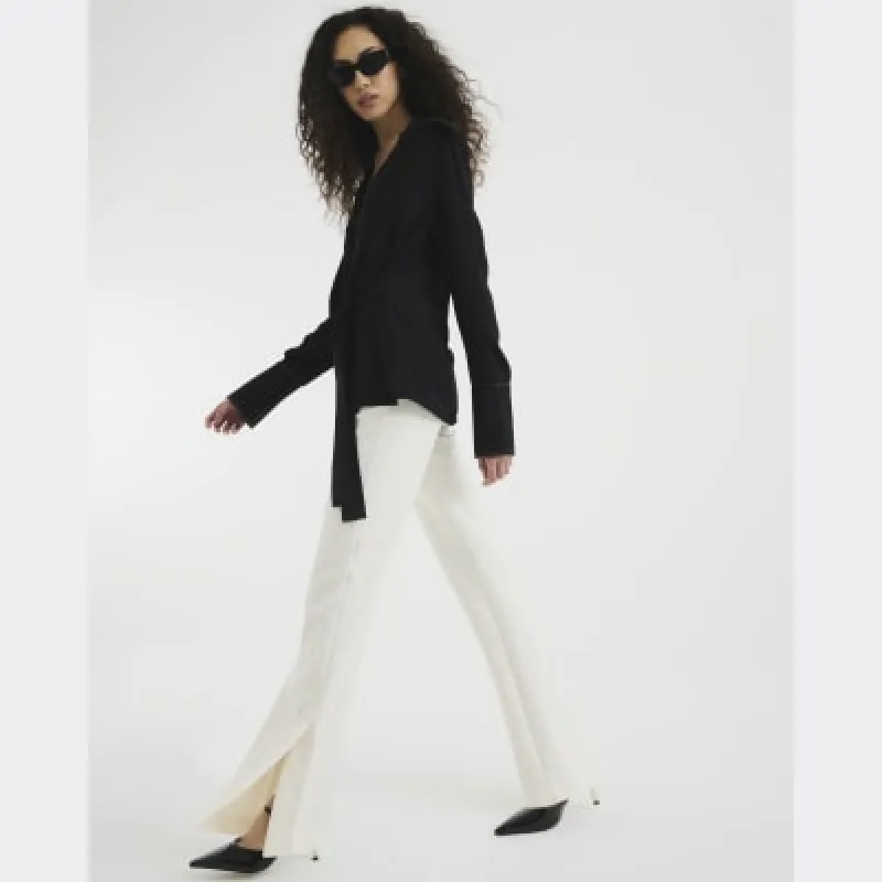 Cream Slim Fit Tailored Flared Trousers sold by River Island